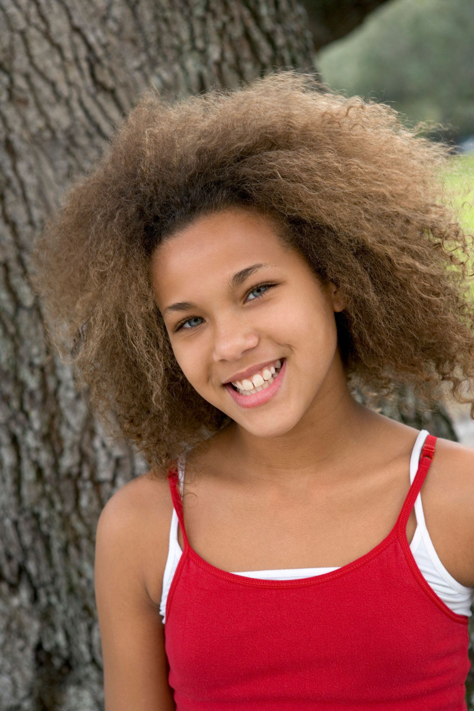 Teen girl smiling outdoors