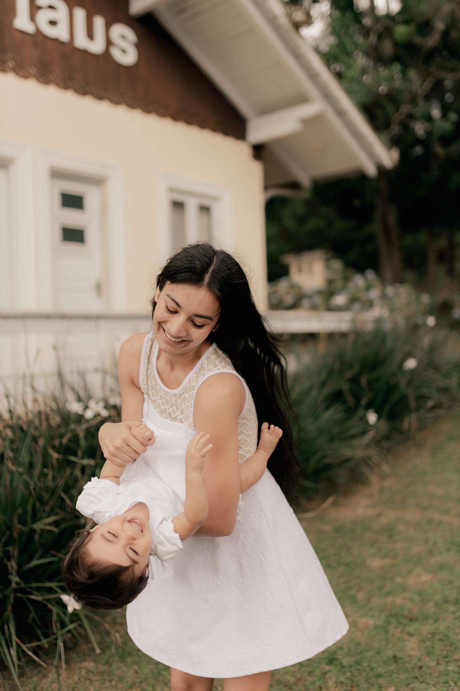 Mother and daughter playing together outside their home
