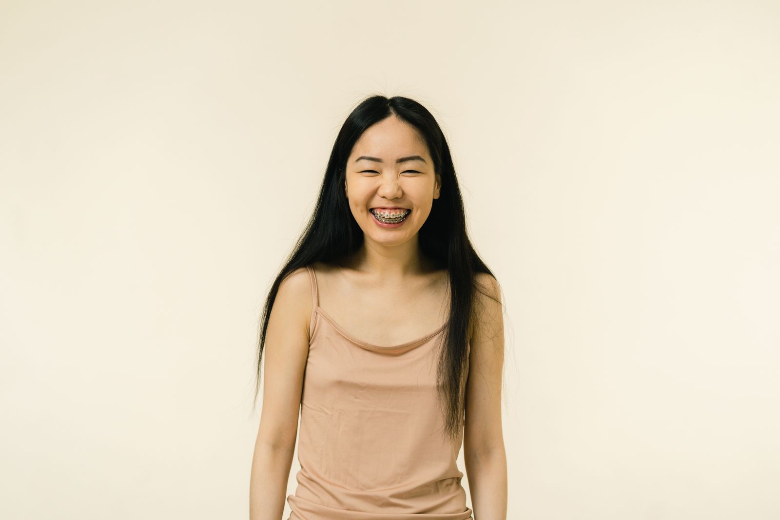 Teen smiling confidently after early orthodontic guidance